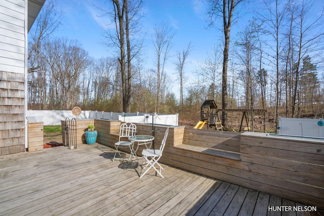 wooden terrace with a playground and a jacuzzi