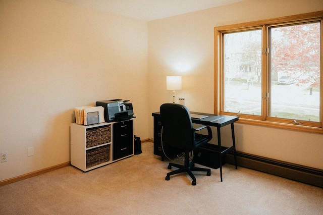 office space featuring light colored carpet, baseboards, and baseboard heating