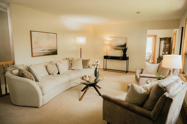 carpeted living area with baseboards