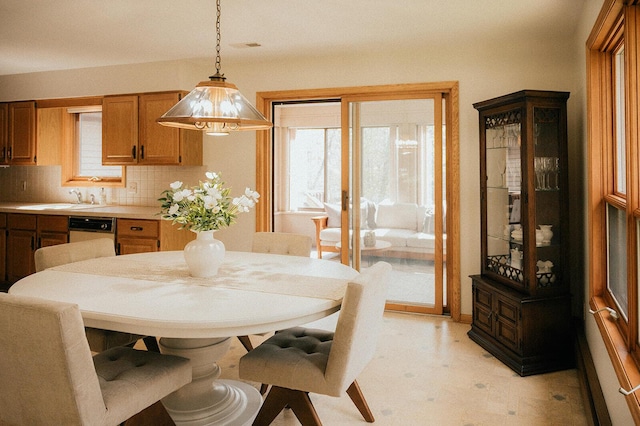dining room with light floors and a healthy amount of sunlight