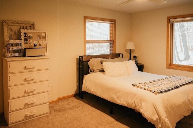 bedroom with baseboards and light carpet