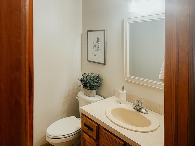 bathroom with toilet and vanity