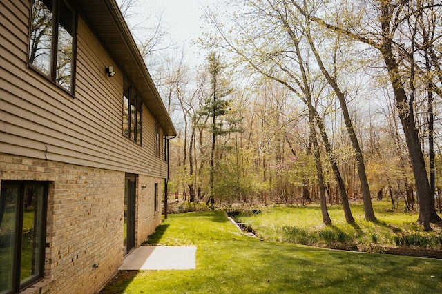 view of yard featuring a view of trees
