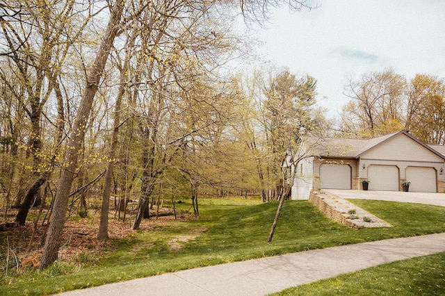 view of front of house with a garage, driveway, and a front lawn