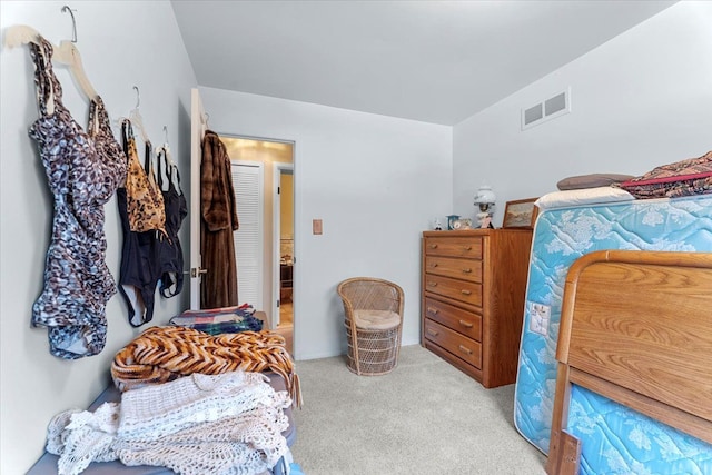 bedroom featuring light colored carpet and visible vents