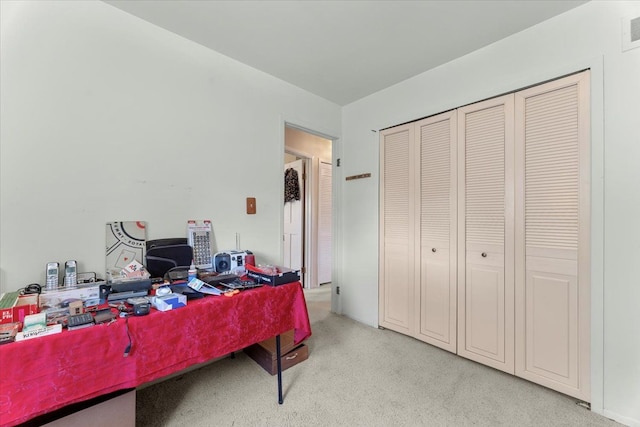 office area with visible vents and light carpet