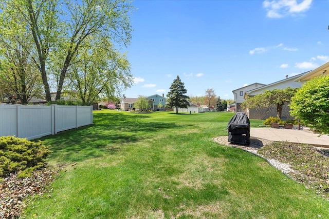 view of yard with fence and a patio