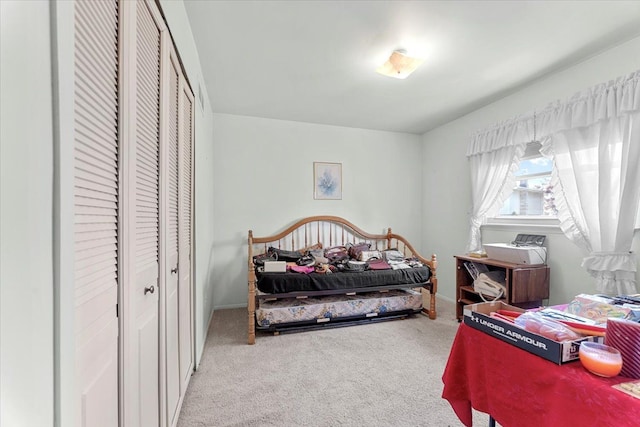 carpeted bedroom featuring baseboards