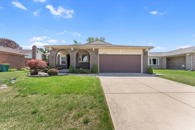 ranch-style home with concrete driveway, brick siding, a front lawn, and a garage
