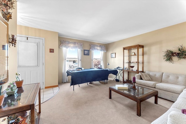living area with baseboards and light colored carpet