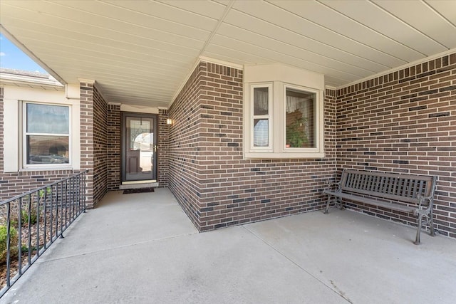 doorway to property with brick siding