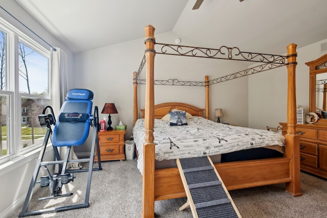 bedroom featuring visible vents, carpet flooring, baseboards, and lofted ceiling