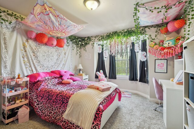 bedroom featuring baseboards and carpet