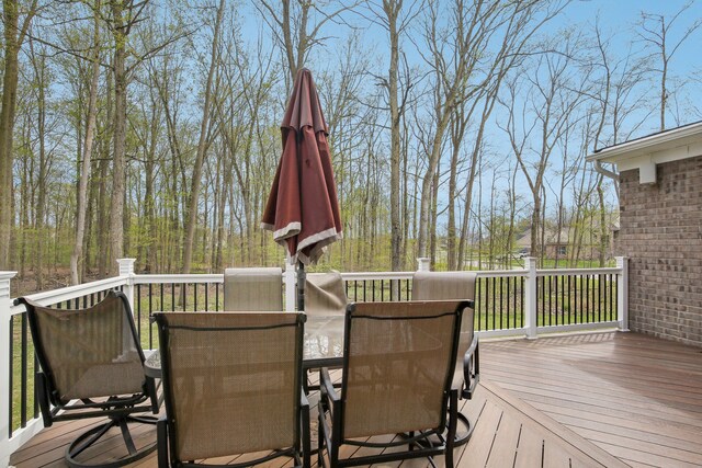 wooden deck featuring outdoor dining area