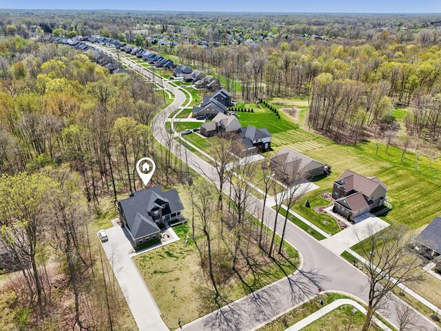 drone / aerial view with a view of trees and a residential view