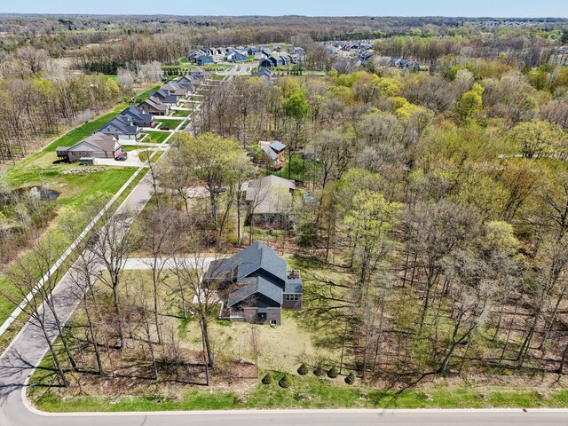 bird's eye view featuring a view of trees and a residential view