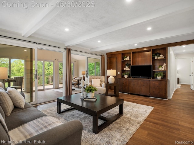 3930 Harris Ln, West Bloomfield, MI 48323 - living room with beam ceiling, plenty of natural light, recessed lighting, wood finished floors, and a textured ceiling