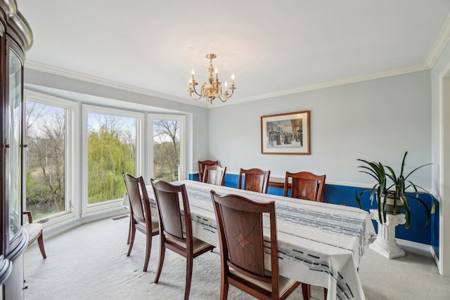 carpeted dining room featuring an inviting chandelier and crown molding