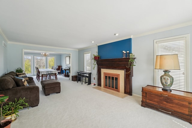 living room featuring an inviting chandelier, plenty of natural light, and carpet