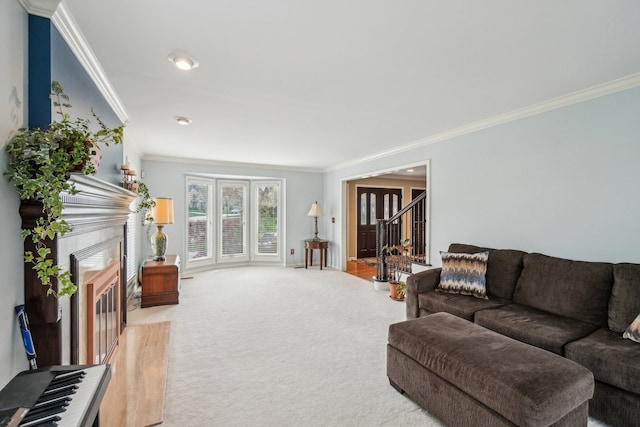 carpeted living area featuring crown molding, a tiled fireplace, and stairway