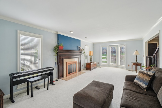 living room with plenty of natural light, carpet floors, ornamental molding, and a premium fireplace