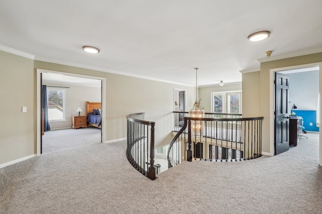 hall featuring crown molding, carpet floors, plenty of natural light, and an upstairs landing