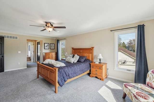 bedroom with visible vents, ornamental molding, baseboards, and light colored carpet