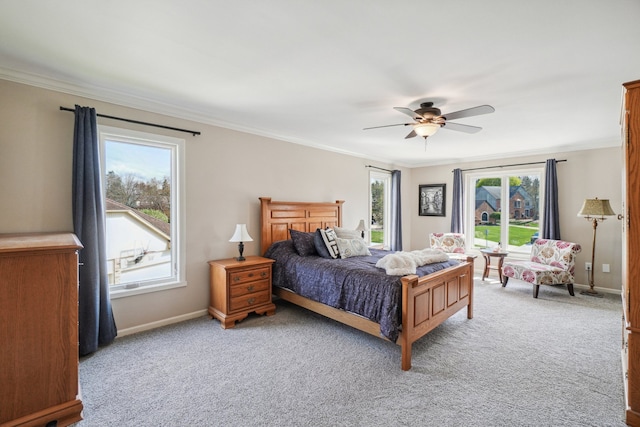 bedroom featuring a ceiling fan, baseboards, ornamental molding, and carpet