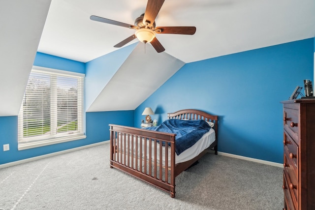carpeted bedroom with baseboards, ceiling fan, and vaulted ceiling