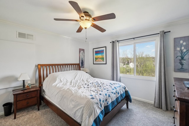 bedroom with visible vents, baseboards, crown molding, and carpet floors
