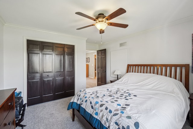 bedroom featuring a closet, carpet flooring, visible vents, and ornamental molding