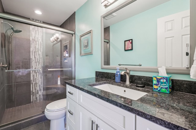 bathroom featuring tile patterned flooring, vanity, toilet, visible vents, and a stall shower