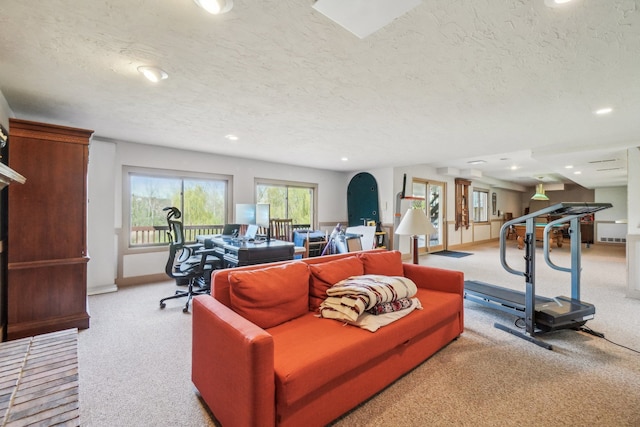 carpeted living room with recessed lighting, a textured ceiling, and baseboards