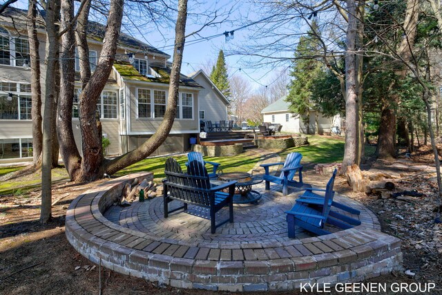 view of yard featuring a patio, an outdoor fire pit, and a wooden deck