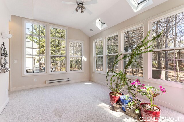 unfurnished sunroom with carpet flooring, baseboards, a baseboard heating unit, and vaulted ceiling with skylight