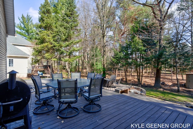 wooden terrace featuring outdoor dining space