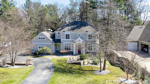 view of front of home with a front lawn and driveway