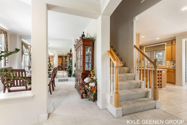 staircase featuring crown molding, recessed lighting, and visible vents