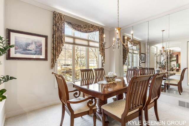 dining room with visible vents, crown molding, a chandelier, and light carpet