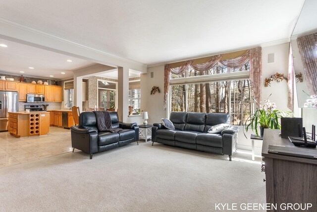 living room featuring recessed lighting, ornamental molding, light tile patterned flooring, and light carpet