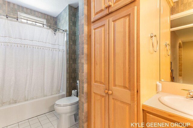 bathroom with vanity, tile patterned flooring, shower / bath combo with shower curtain, and toilet