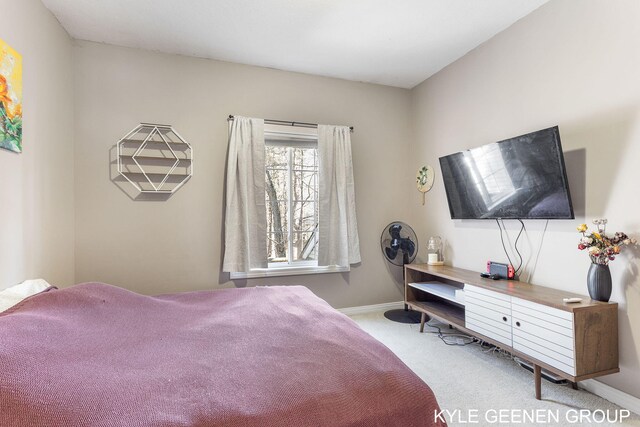 carpeted bedroom featuring baseboards