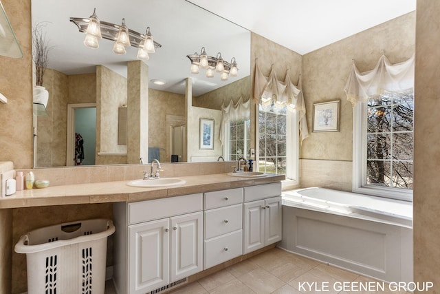 full bathroom with tile patterned floors, visible vents, a sink, and a bath