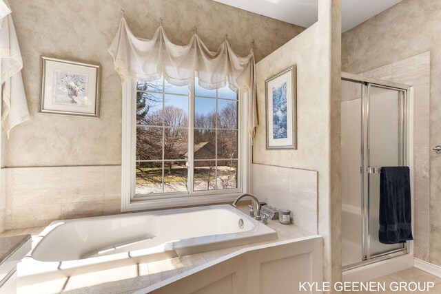 bathroom with a garden tub and a stall shower
