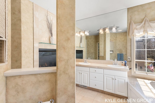 full bath featuring visible vents, a sink, tile patterned floors, and a fireplace