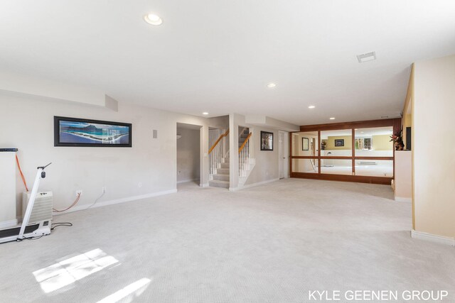 interior space featuring visible vents, stairway, baseboards, light carpet, and recessed lighting