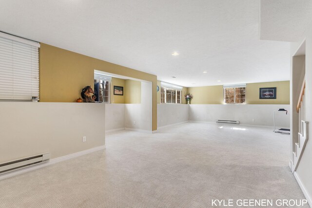 basement featuring carpet floors, recessed lighting, baseboards, a baseboard radiator, and a baseboard heating unit