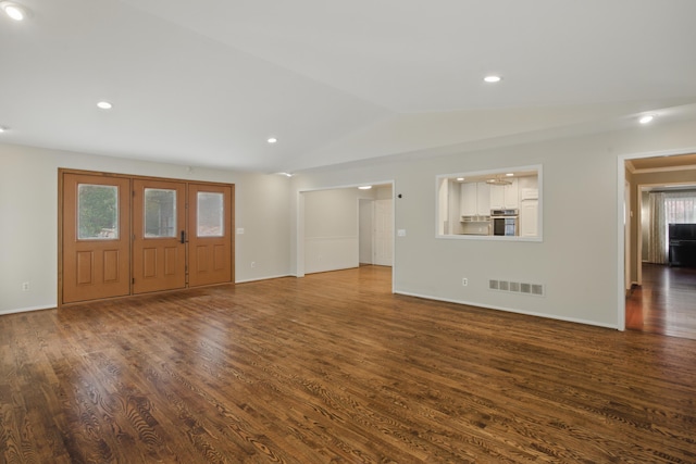 unfurnished living room featuring recessed lighting, lofted ceiling, dark wood-style floors, and visible vents