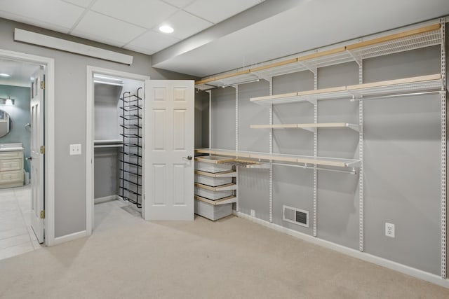 basement featuring baseboards, recessed lighting, visible vents, and light carpet