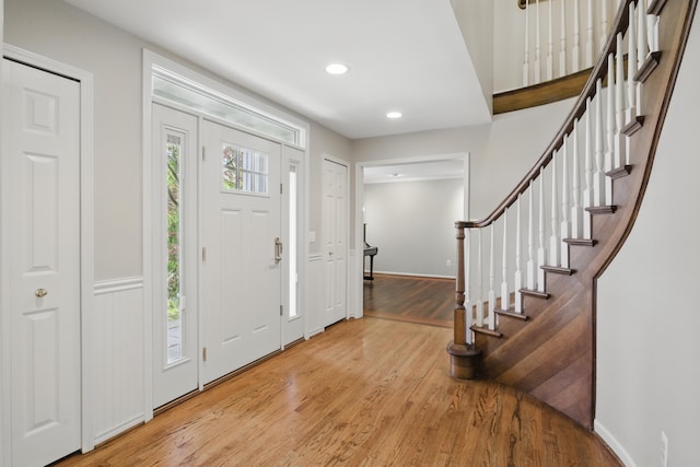 entrance foyer with stairs, recessed lighting, baseboards, and light wood-type flooring